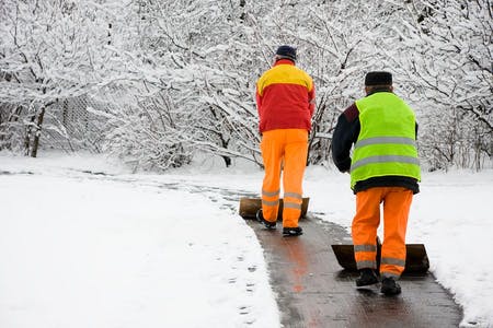 workers shoveling snow